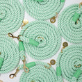 Load image into Gallery viewer, Multiple green rope dog leashes with gold hardware on a white background