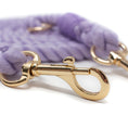 Load image into Gallery viewer, Close up of gold hardware of a purple braided dog rope leash on a white background