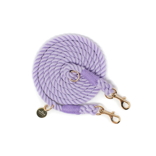 Purple braided rope leash with gold hardware on a white background