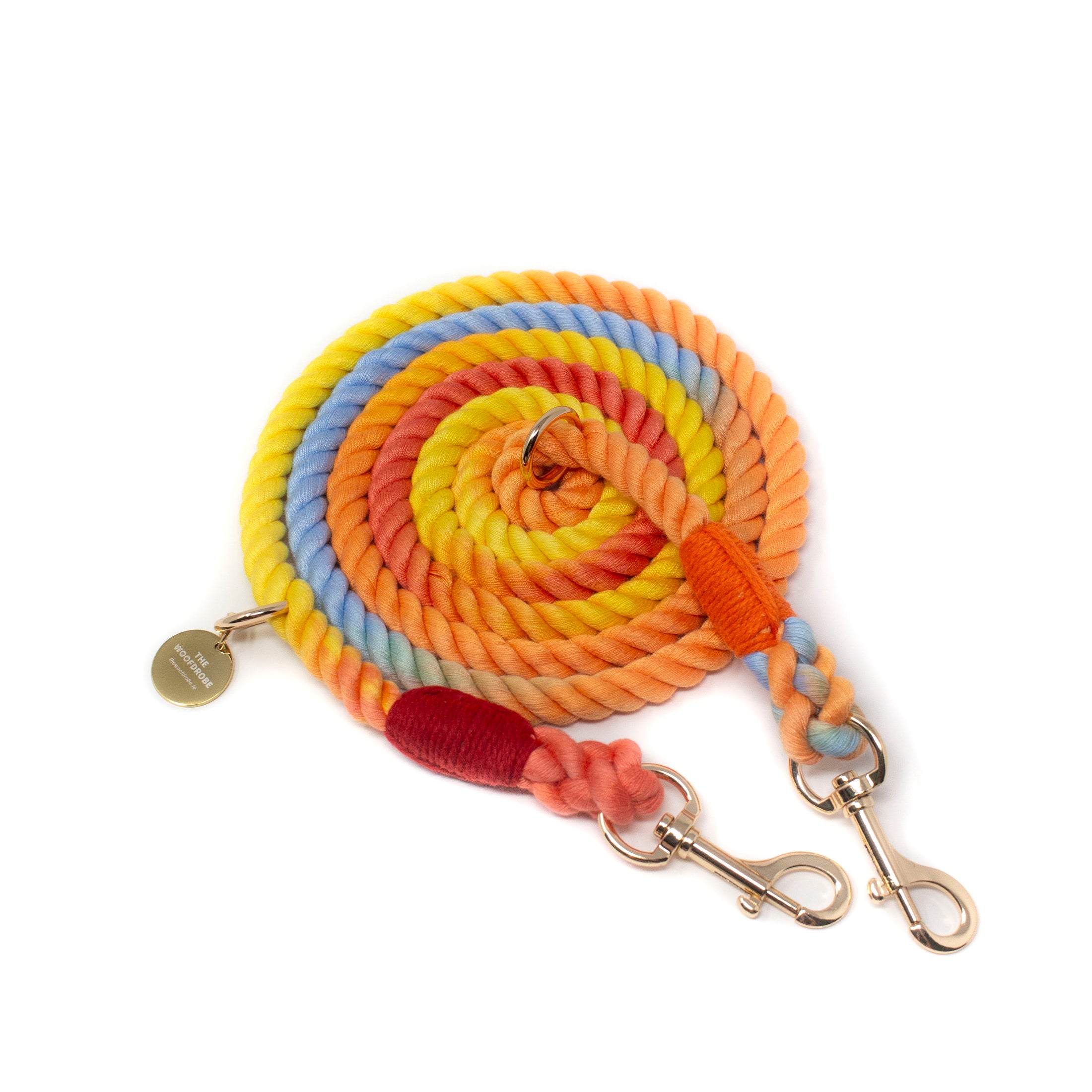 Multicoloured rope leash with gold hardware on a white background