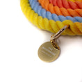 Load image into Gallery viewer, Multicoloured rope leash with gold tag featuring The Woofdrobe logo, on a white background
