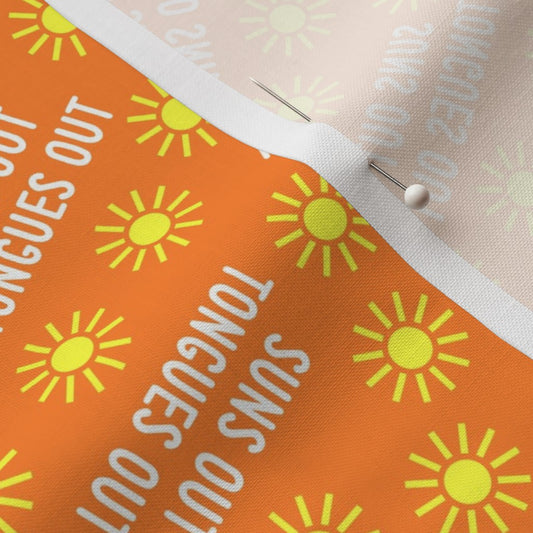 Section of orange fabric with suns on